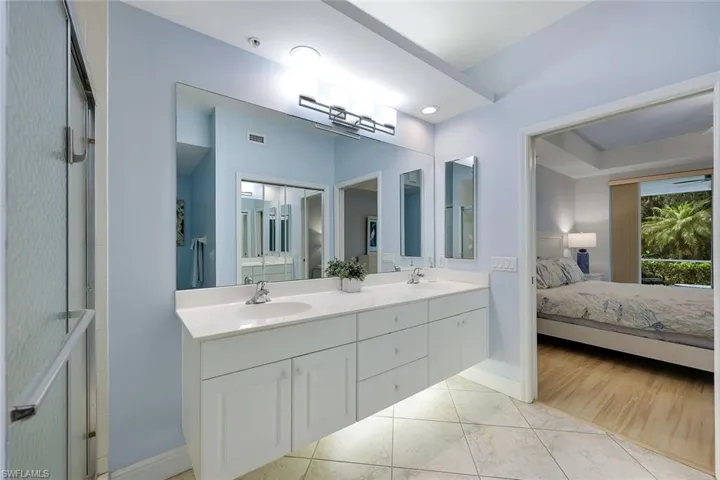 Vanity featuring a dual sink with white cabinetry and countertop