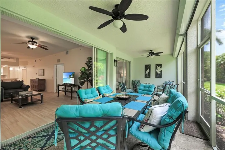 Screened lanai featuring tile flooring and multiple ceiling fans