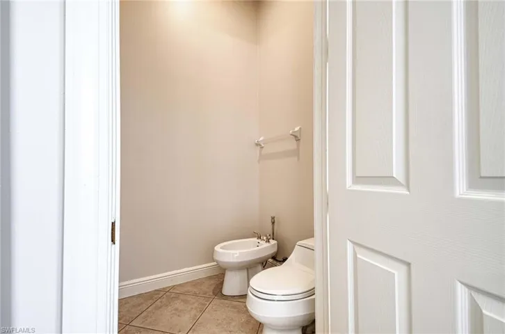 Bathroom featuring tile patterned flooring, a bidet, and toilet