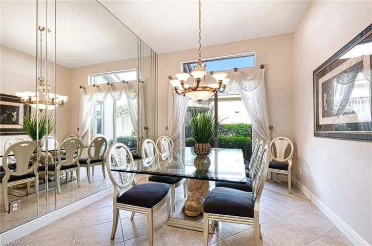 Tiled dining space with a chandelier