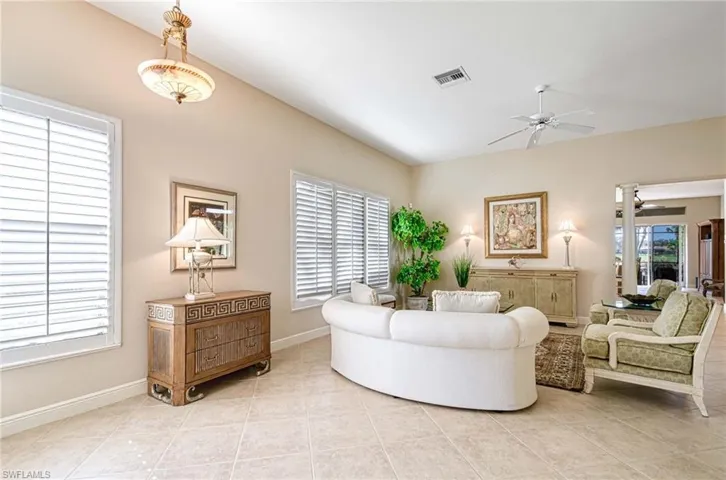 Tiled living room featuring a healthy amount of sunlight