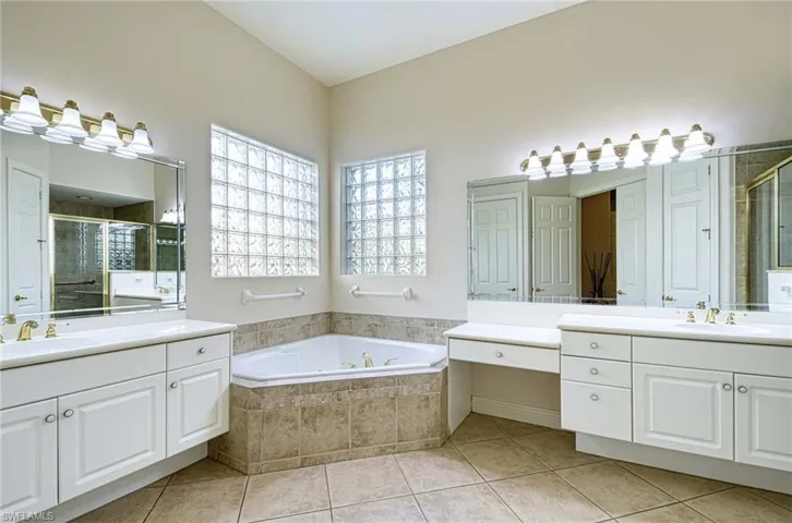 Bathroom featuring vanity, tile patterned floors, and independent shower and bath