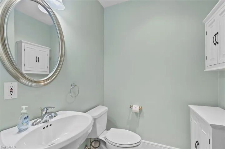 Half bath with a sink and toilet