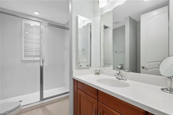 Full bathroom featuring a shower stall, vanity, and recessed lighting