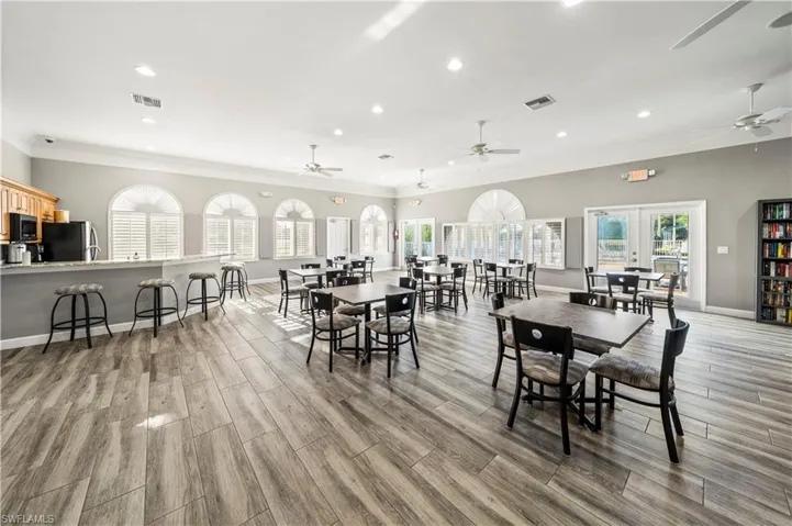Dining space featuring ceiling fan, crown molding, and french doors