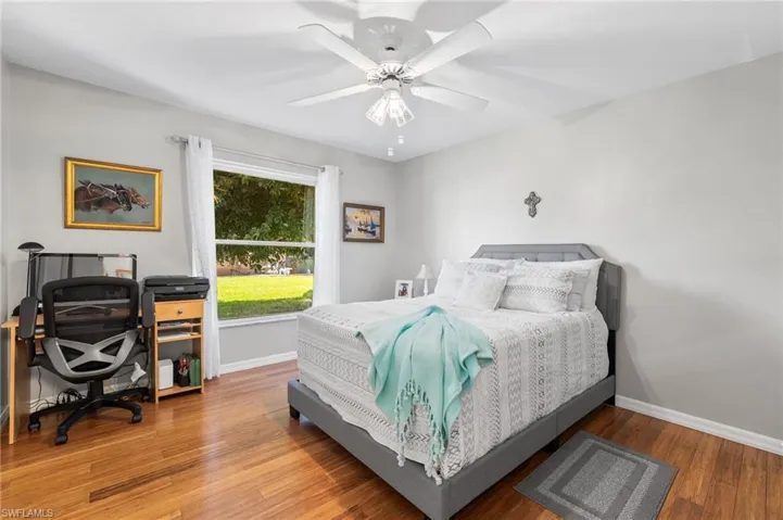 Bedroom featuring hardwood / wood-style flooring and ceiling fan