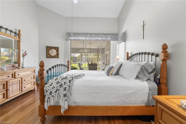 Bedroom featuring lofted ceiling, access to outside, ceiling fan, and light hardwood / wood-style floors