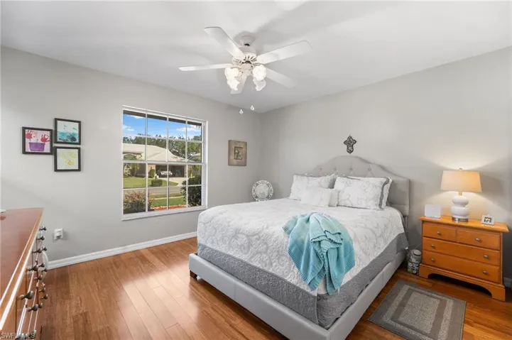 Bedroom with hardwood / wood-style floors and ceiling fan