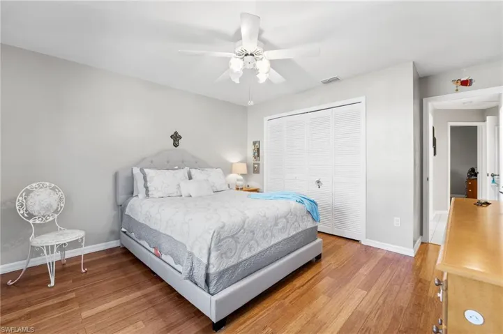 Bedroom featuring hardwood / wood-style flooring, ceiling fan, and a closet