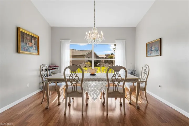 Dining room featuring hardwood / wood-style floors and a chandelier