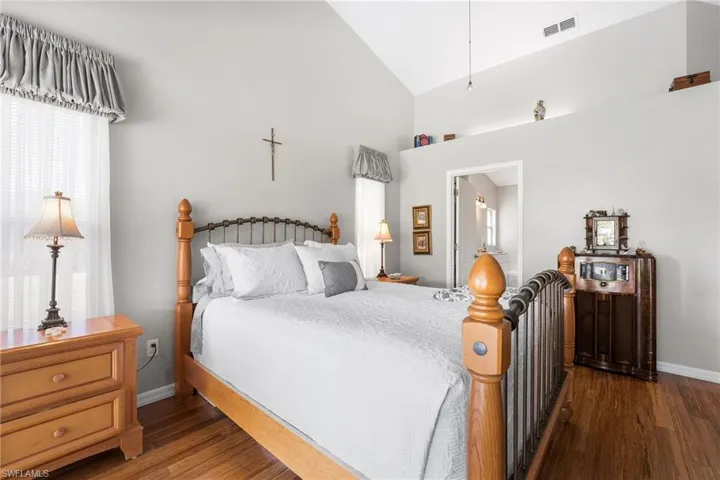 Bedroom featuring dark hardwood / wood-style floors and lofted ceiling