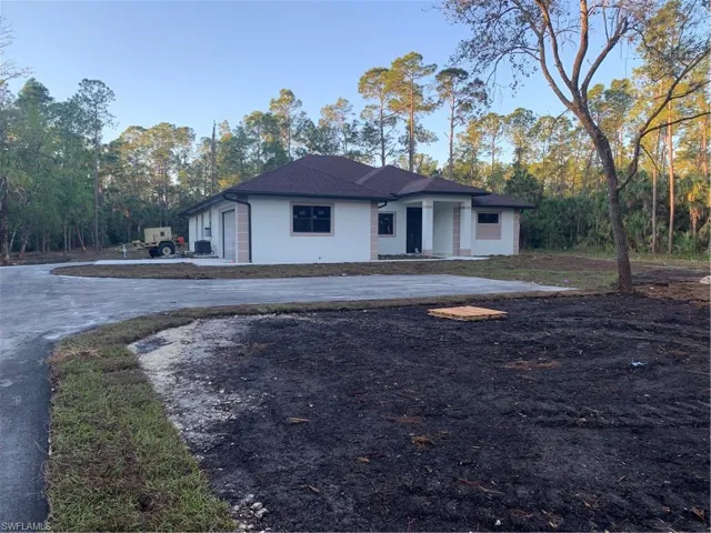 View of front of property with concrete driveway and stucco siding