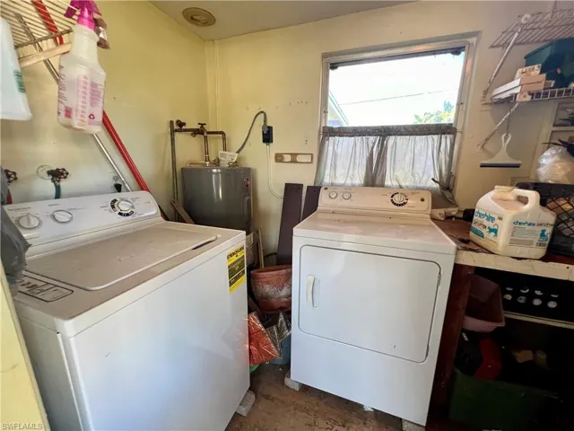 Washroom with water heater and washer and dryer