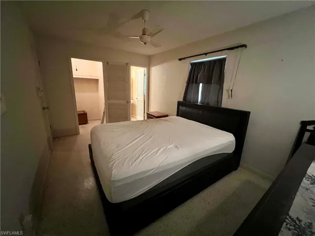 Bedroom featuring ceiling fan, ensuite bathroom