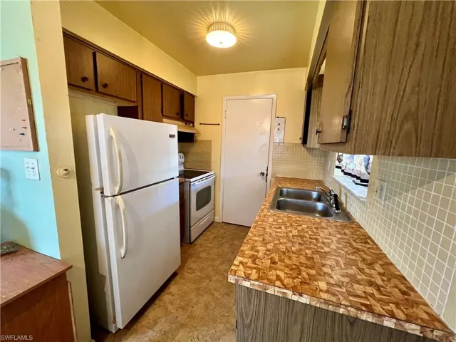 Kitchen, wall backsplashappliances, and sink