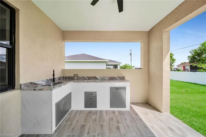 View of patio with area for grilling and sink