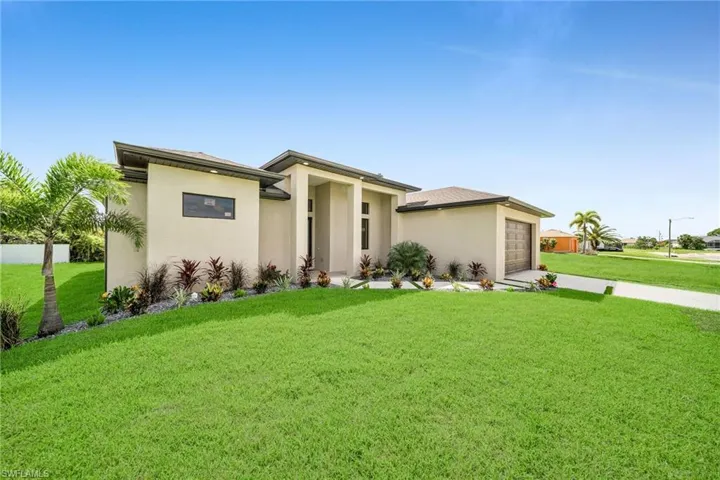 Prairie-style home with a front lawn and a garage