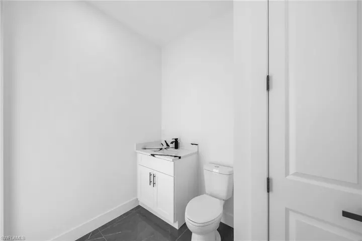 Bathroom with tile patterned flooring, toilet, and vanity