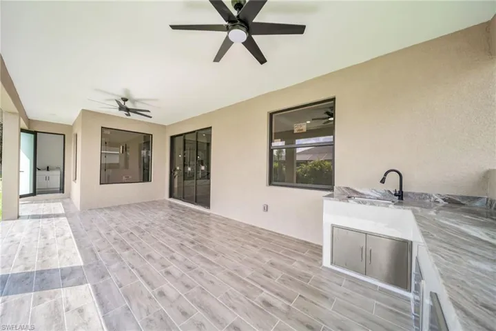 View of patio / terrace featuring ceiling fan and sink
