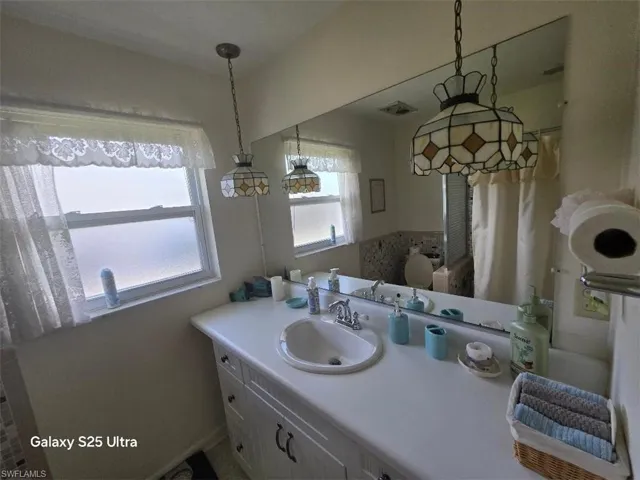 Bathroom with vanity and visible vents