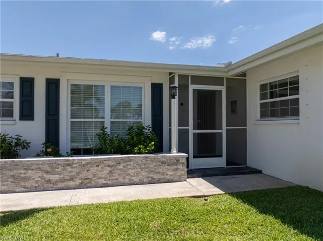 Doorway to property with stucco siding