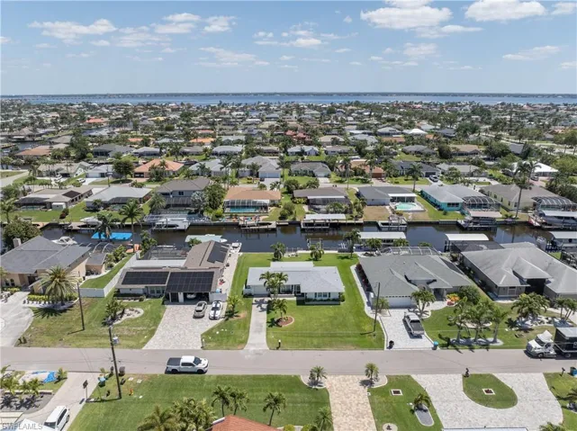Aerial view featuring a water view and a residential view