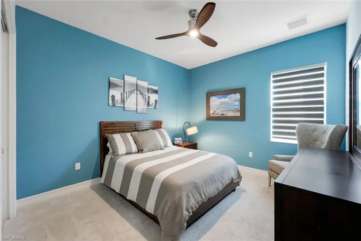 Bedroom with light carpet and ceiling fan