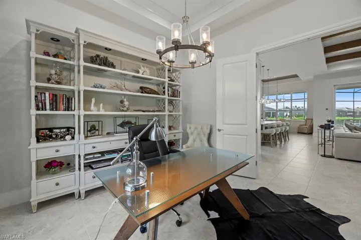 Tiled home office with a notable chandelier