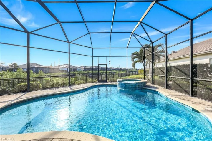 View of swimming pool featuring a lanai