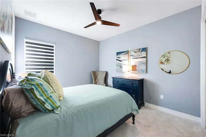Bedroom featuring ceiling fan and light colored carpet