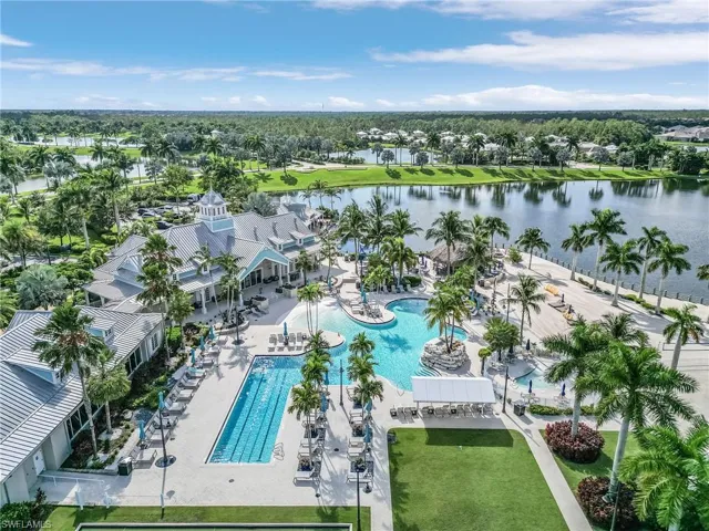 Aerial view of a pool and a nearby body of water
