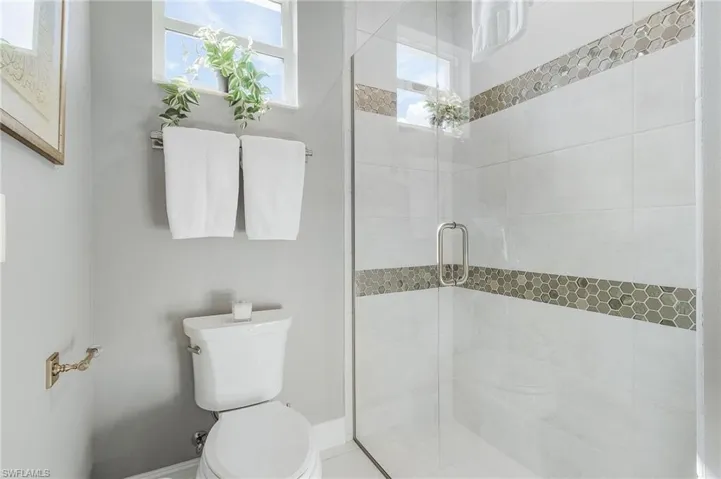 Full bath featuring a stall shower and tile patterned floors