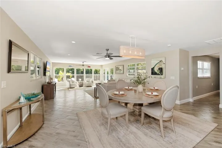 Dining area featuring a ceiling fan and light wood-type flooring