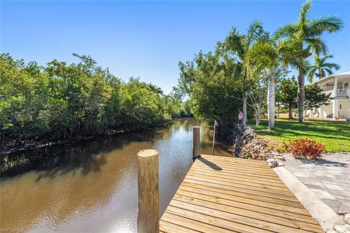 Dock featuring a water view and a lawn