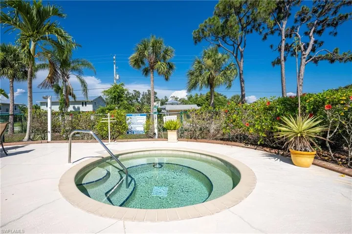 View of swimming pool featuring a hot tub