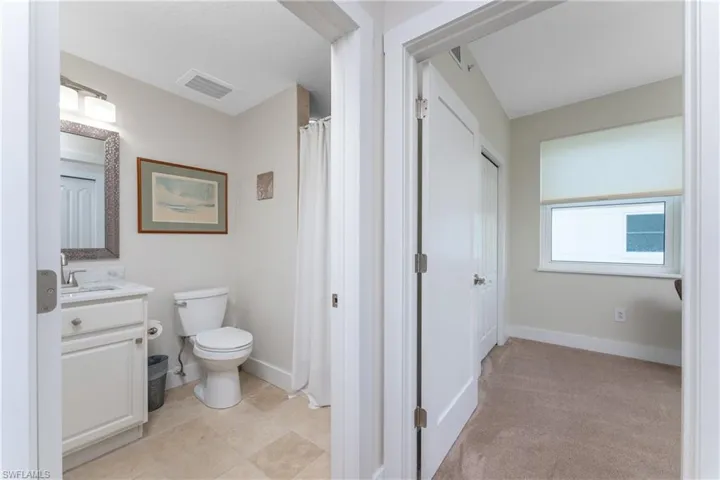 Bathroom featuring tile flooring, toilet, and vanity