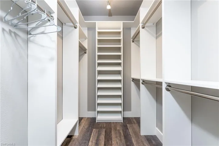 Walk in closet featuring dark wood-type flooring