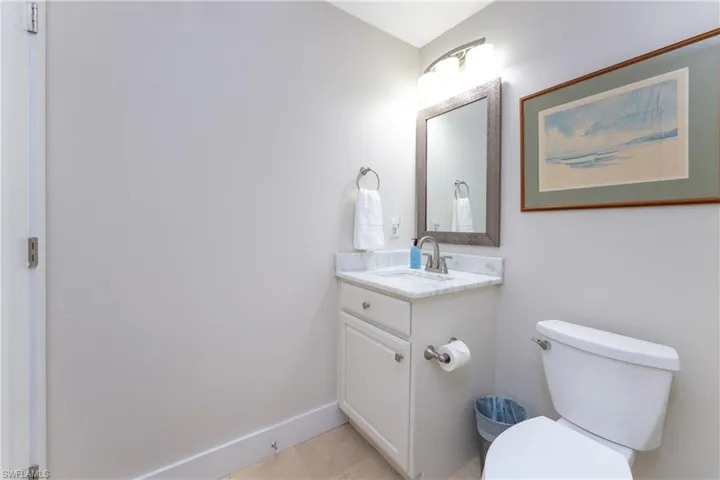Bathroom with oversized vanity, toilet, and tile floors