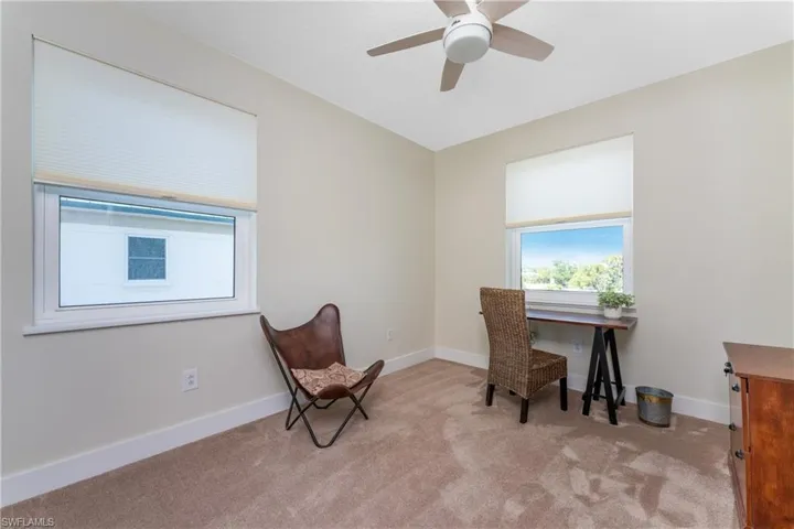 Carpeted office space with ceiling fan