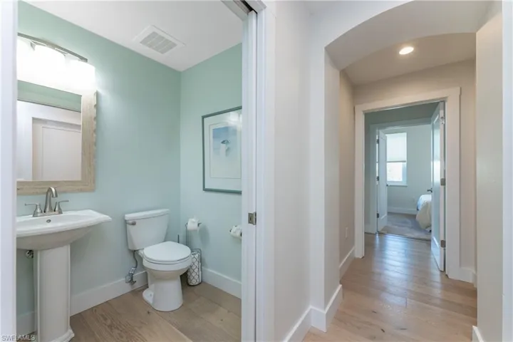 Bathroom featuring wood-type flooring and toilet