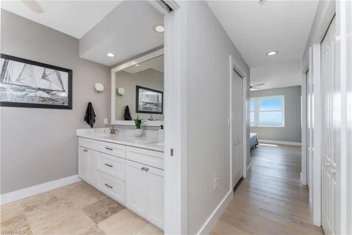 Bathroom with ceiling fan, hardwood / wood-style flooring, and vanity
