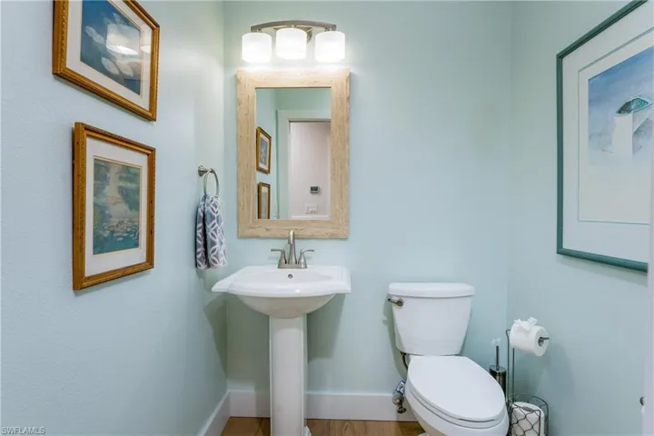 Bathroom with toilet and hardwood / wood-style floors