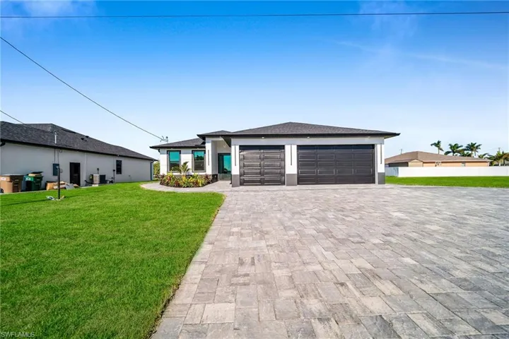 Prairie-style house with a front lawn and a garage