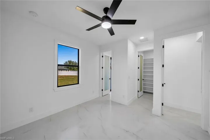 Unfurnished bedroom featuring ceiling fan