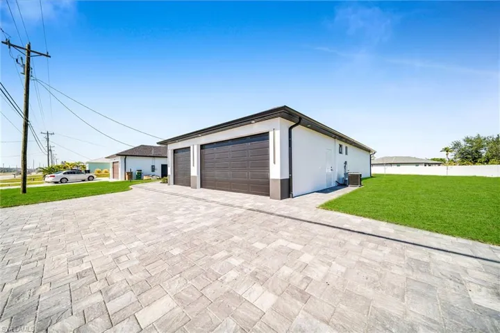 View of property exterior with a lawn and central AC