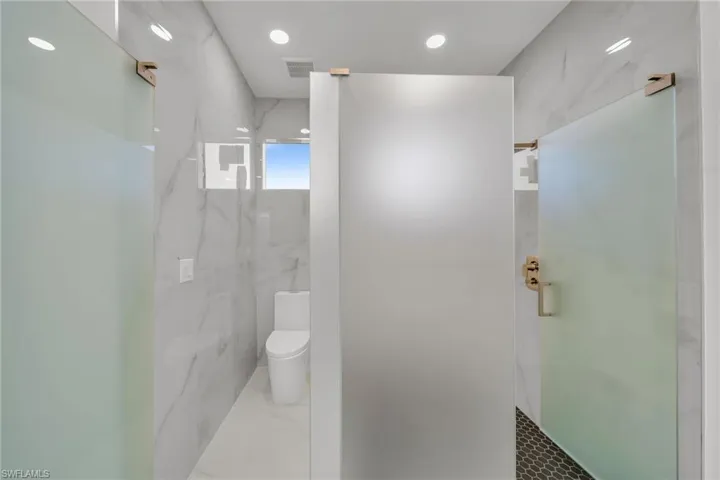 Bathroom with toilet and tiled shower
