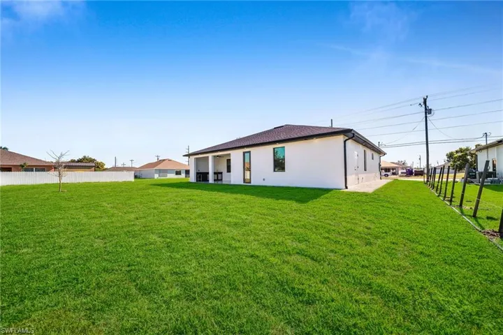 Rear view of property featuring a yard