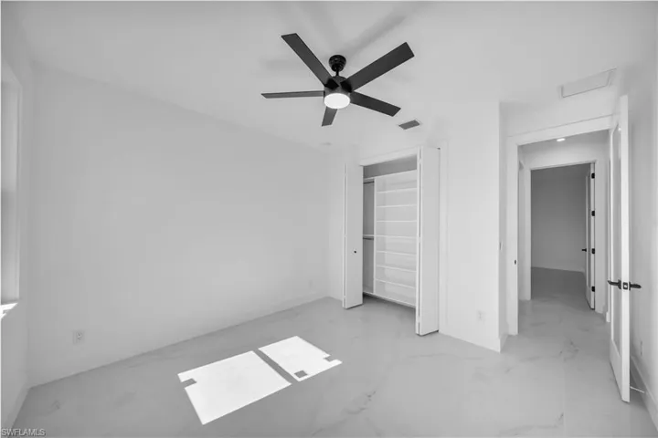 Unfurnished bedroom featuring a closet and ceiling fan