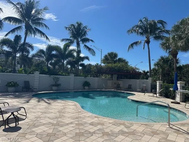 Community pool with a patio