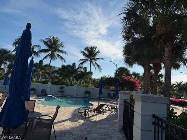 View of swimming pool with a fenced backyard and a patio